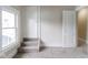 Bedroom with stairs, window, and carpet at 3419 Carrollton Ave, Indianapolis, IN 46205
