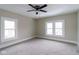 Spacious bedroom with neutral carpet, ceiling fan, and lots of natural light at 3419 Carrollton Ave, Indianapolis, IN 46205