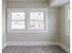 Bright bedroom with neutral walls, large window, and plush carpet at 3419 Carrollton Ave, Indianapolis, IN 46205