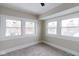 Sunlit bedroom with ample windows, neutral walls, and plush carpet at 3419 Carrollton Ave, Indianapolis, IN 46205