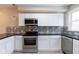 Modern kitchen features white cabinets, stainless steel appliances, and stylish backsplash at 3419 Carrollton Ave, Indianapolis, IN 46205