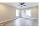Bright living room featuring stylish gray wood floors, large windows, and updated white wall at 3419 Carrollton Ave, Indianapolis, IN 46205