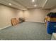 Unfinished basement area with carpet and a table, boxes, and other household goods at 3681 S Station Dr, Columbus, IN 47203