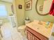 Inviting bathroom featuring a toilet, sink with wood cabinets, and a laundry area with a washing machine at 3681 S Station Dr, Columbus, IN 47203
