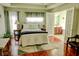 Bright bedroom with hardwood floors, a ceiling fan, and a doorway to an ensuite bathroom at 3681 S Station Dr, Columbus, IN 47203