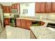 Spacious kitchen featuring wood cabinets, granite countertops, and modern appliances at 3681 S Station Dr, Columbus, IN 47203