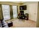 Well-lit home office featuring a large window, a ceiling fan, and comfortable seating at 3681 S Station Dr, Columbus, IN 47203