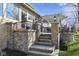 Multi-tiered back patio with stone stairs and accents, black metal railing, and a pergola at 3841 Falls Cir, Carmel, IN 46033