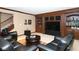 Basement with seating area featuring comfortable leather furniture, an area rug, and built in shelving at 3841 Falls Cir, Carmel, IN 46033