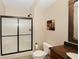 Cozy bathroom featuring a step-in shower with a glass door, granite counters, and a framed mirror at 3841 Falls Cir, Carmel, IN 46033