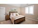 Comfortable bedroom with a wooden bed frame, carpeted floor, and golf-themed wall decor at 3841 Falls Cir, Carmel, IN 46033