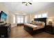 Serene main bedroom suite with tray ceilings, a bay window, and hardwood floors at 3841 Falls Cir, Carmel, IN 46033