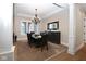 Dining room features tray ceiling, dark wood table and sideboard, creating a stylish and functional space for gatherings at 3841 Falls Cir, Carmel, IN 46033