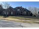 Elegant brick home featuring a well-manicured lawn and classic architectural details under a clear blue sky at 3841 Falls Cir, Carmel, IN 46033