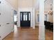 Elegant foyer with hardwood floors, soaring ceilings, and a stylish black front door at 3841 Falls Cir, Carmel, IN 46033
