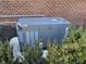 Image of a home generator with shrubbery around it, installed along a brick wall at 3841 Falls Cir, Carmel, IN 46033