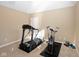 Functional gym with a treadmill, exercise bike, carpeted floor, and weights at 3841 Falls Cir, Carmel, IN 46033