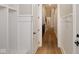Bright hallway with paneled walls, hardwood floors, and detailed trim showcases the home's craftsmanship and design at 3841 Falls Cir, Carmel, IN 46033