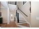 Elegant hallway with hardwood floors, staircase with iron railings, and natural light at 3841 Falls Cir, Carmel, IN 46033
