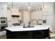 Bright kitchen features white cabinets, stainless steel appliances, marble backsplash, and an island with a black base at 3841 Falls Cir, Carmel, IN 46033