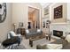 Bright living room with fireplace, elegant furnishings, and neutral decor showcases a cozy yet sophisticated interior at 3841 Falls Cir, Carmel, IN 46033