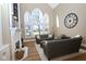 Bright living room featuring a fireplace, hardwood floors, large windows, and neutral decor creating an inviting and spacious area at 3841 Falls Cir, Carmel, IN 46033