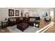 Spacious living room with a large leather sofa, ottoman, area rug, and modern decor at 3841 Falls Cir, Carmel, IN 46033