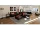 Spacious open-concept living space with hardwood floors seamlessly connects living, kitchen, and dining areas at 3841 Falls Cir, Carmel, IN 46033