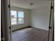 Bright bedroom featuring pristine white walls, wood-look flooring, and double windows at 4067 Denali Dr, Indianapolis, IN 46235