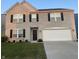 Charming two-story brick home with attached two-car garage and well-manicured lawn at 4067 Denali Dr, Indianapolis, IN 46235