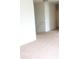 Spacious hallway with neutral carpeting and a staircase at 4067 Denali Dr, Indianapolis, IN 46235