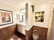 Charming bathroom with marble-look tile, stylish lighting and lots of decorative art at 430 N Park Ave # 302, Indianapolis, IN 46202