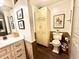 Bright bathroom with a large cream linen closet, toilet with print, and an elegant cream vanity at 430 N Park Ave # 302, Indianapolis, IN 46202