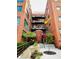 Exterior shot of a brick apartment building with black balconies, a brick entryway, and lush green landscaping at 430 N Park Ave # 302, Indianapolis, IN 46202