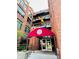 Brick building featuring a red awning with black balconies on each level and large glass windows at 430 N Park Ave # 302, Indianapolis, IN 46202