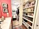Walk in closet featuring carpet, shelving, chair and access to bathroom at 430 N Park Ave # 302, Indianapolis, IN 46202