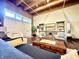 Living room featuring brick accent wall, wood floors and comfortable furniture at 430 N Park Ave # 302, Indianapolis, IN 46202