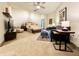 Spacious main bedroom featuring a ceiling fan, seating area, king-size bed, and neutral carpet at 430 N Park Ave # 302, Indianapolis, IN 46202