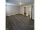 Spacious carpeted bedroom with gray walls and two doorways leading to other rooms at 5142 Tuscany Ln, Indianapolis, IN 46254
