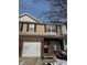Charming two-story townhome featuring a brick facade, garage, and well-maintained front yard at 5142 Tuscany Ln, Indianapolis, IN 46254