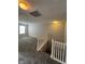Upstairs hallway leading to bedrooms with plush carpeting and natural light from a window at 5142 Tuscany Ln, Indianapolis, IN 46254