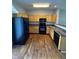 Functional kitchen featuring a full suite of black appliances, wood cabinets, and sleek countertops at 5142 Tuscany Ln, Indianapolis, IN 46254