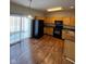 Well-equipped kitchen featuring black appliances, ample wood cabinetry, and sliding glass doors at 5142 Tuscany Ln, Indianapolis, IN 46254