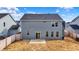 Back exterior showcasing the home's design with a small concrete patio and fenced yard at 526 Carroll St, New Whiteland, IN 46184