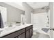 Bathroom with double sink vanity, gray walls, tile flooring, and a shower-tub combination at 526 Carroll St, New Whiteland, IN 46184