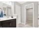 Bathroom features a single vanity with dark cabinets and a view of the walk-in closet at 526 Carroll St, New Whiteland, IN 46184
