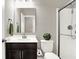 Bathroom featuring dark wood vanity with white sink, mirror, shower with glass door, and toilet at 526 Carroll St, New Whiteland, IN 46184