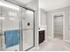 Bathroom features a glass enclosed shower, single vanity and access to the walk-in closet at 526 Carroll St, New Whiteland, IN 46184