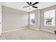 Bedroom with neutral walls, carpeted floors, ceiling fan, and double windows offering exterior views at 526 Carroll St, New Whiteland, IN 46184