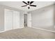 Bedroom with neutral walls, carpeted floors, ceiling fan, closet and doorway leading to other rooms at 526 Carroll St, New Whiteland, IN 46184